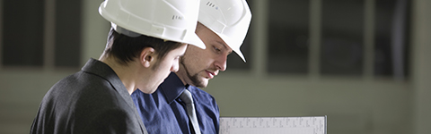 Two men discussing floor plans